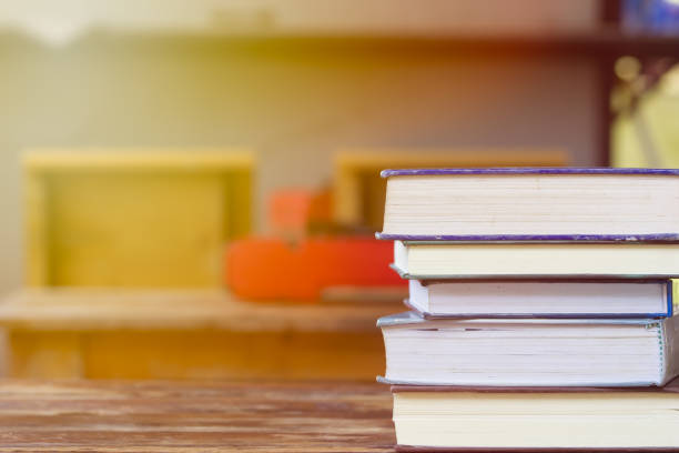 istock Education and reading concept - group of stack books on the wooden table with copy space for text. Home school concept. Learning at home with parent. 1006464758