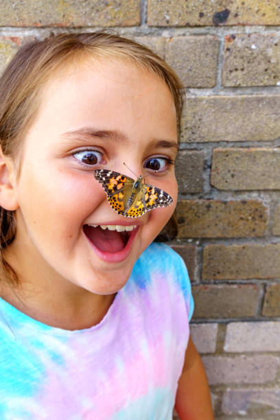 istock Ten year old girl with butterfly on her nose 1006469152