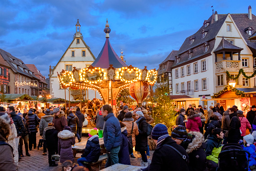 People enjoying the advent in Place du Marché in the old town of Obernai, where every year a traditional Christmas market is held. Obernai is an important tourist destination in Alsace, eastern France.