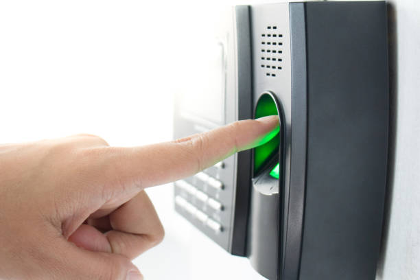 istock employee scanning fingerprint to record working time 1006469718