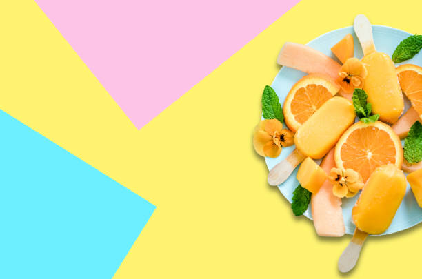 Fruit popsicles ice cream on pastel background, flat lay design