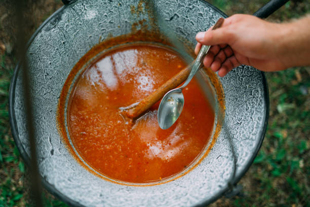 Big rustic metal pot outdoor soup in it