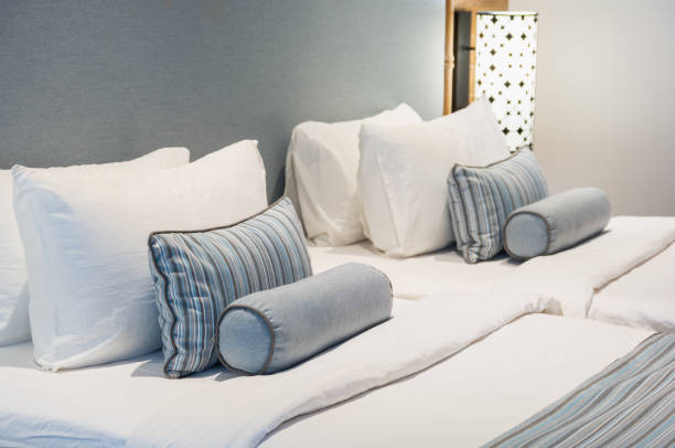 Comfort and elegant bed, double bed in beautiful bedroom with lamp light.