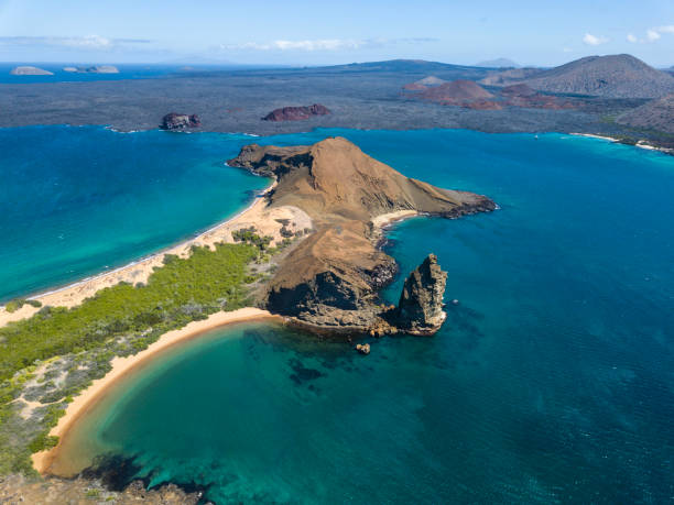 Aerial view of Pinnacle Rock, Bartolome Island, Galapagos, Ecuador Aerial view of the famous Pinnacle Rock on the small island of Bartolome, Galapagos, Ecuador. In the background is Santiago island. isla san salvador stock pictures, royalty-free photos & images