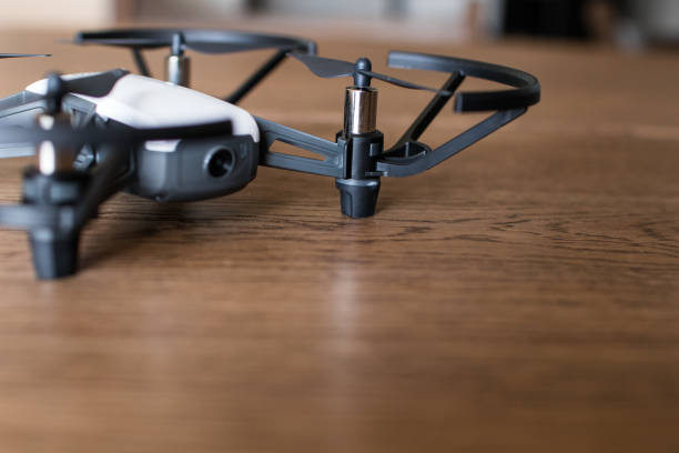 istock Mini black and white indoor drone on a wooden table. 1006486070