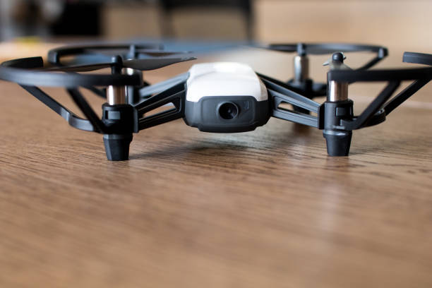 istock Mini black and white indoor drone on a wooden table. 1006486080