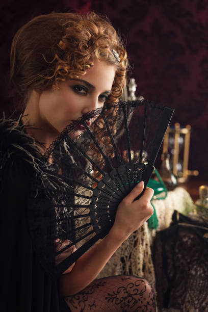 Young retro woman with lace fan