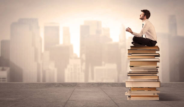 istock Man sitting on books in the city 1006496678