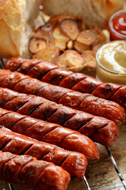 istock Grilled sausages in oven pan with garlic and onion 1006497016