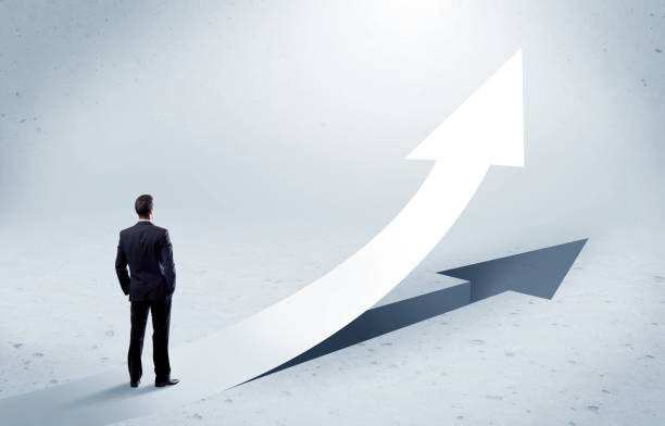 istock Arrow pointing up with standing salesman 1006499746