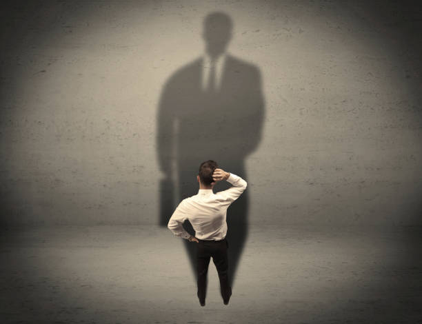 istock Businessman looking at big shadow concept 1006500032