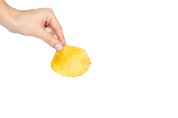 istock Golden potato chip with hand, isolated on white background. copy space template 1006500118