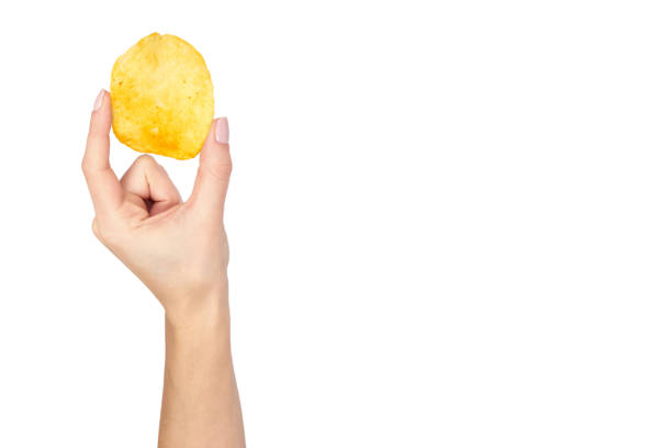 istock Golden potato chip with hand, isolated on white background. copy space template 1006500126