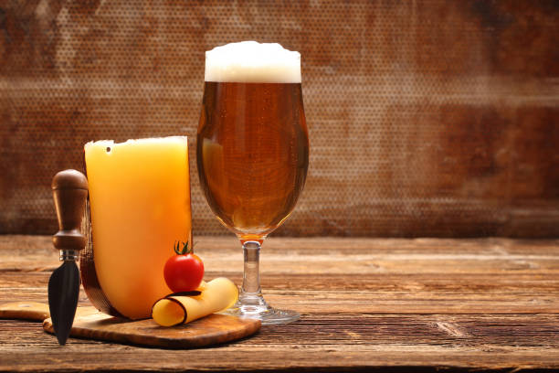 istock Beer and yellow cheese appetizer on brown vintage background 1006503032