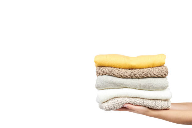 istock Pile of foldet cloth with hand, isolated on white background. copy space template 1006503496