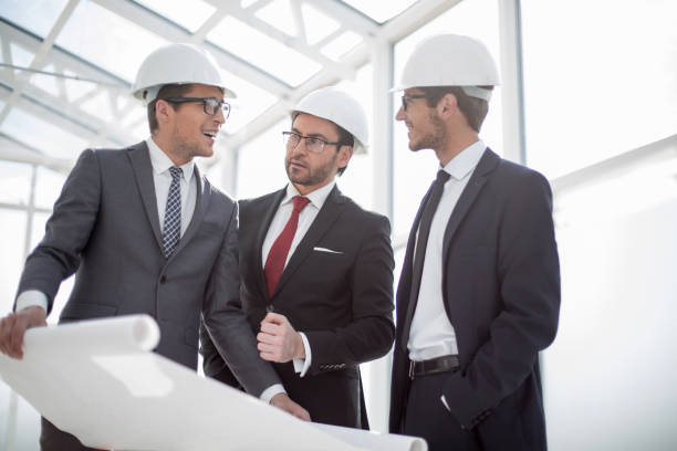 istock businessman asks questions to the chief architect 1006503606