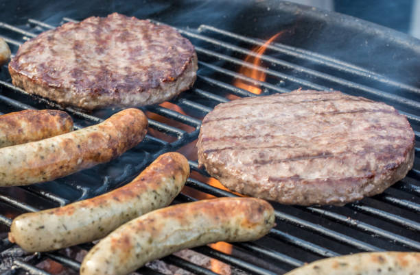istock Sausages and burgers on the grill 1006503686