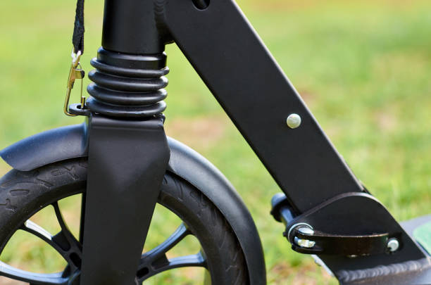 istock Black folding kick scooter, close up parts, front wheel 1006504222