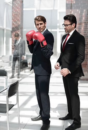 lawyer advises the businessman in Boxing gloves . the concept of business competition