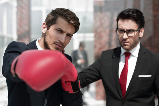 lawyer in Boxing gloves and his supervisor. the concept of business competition
