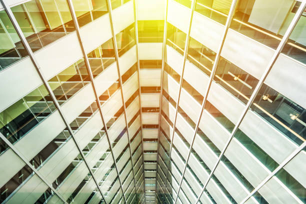 Asia Business concept for real estate, corporate construction and ecology - perspective looking up view of panoramic triangle abstract city building with blue sky and sun light