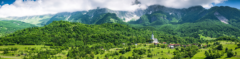 Panoramic image of Slovenia Julian Alps, farmland and village.
