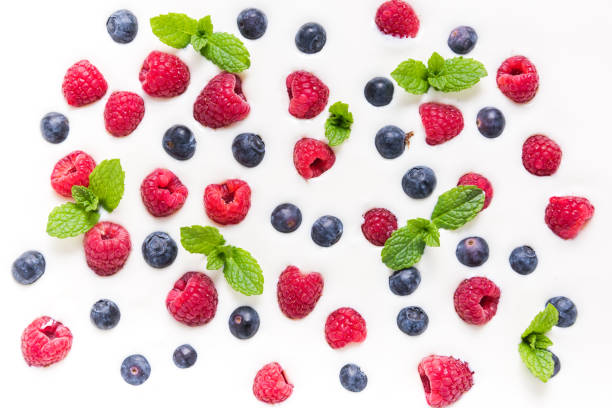 istock Food background, raspberries and blueberies on yogurt 1006512138