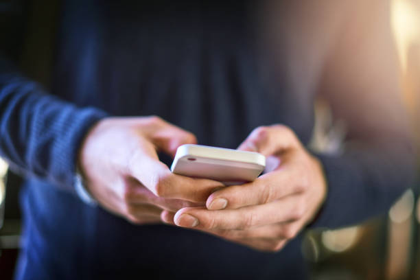 You've got to stay connected as a student Closeup shot of an unrecognizable university student using a cellphone at campus text messaging stock pictures, royalty-free photos & images