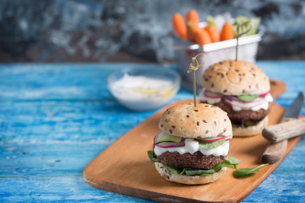 istock Veggie falafel burgers with fresh vegetables on blue background 1006518594