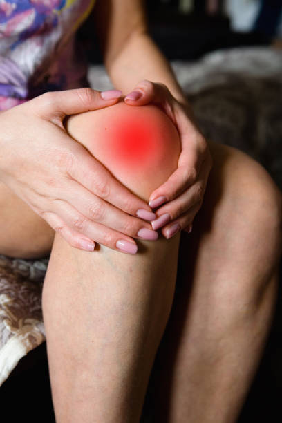 istock Beautiful female hands lie on the knee. 1006524804