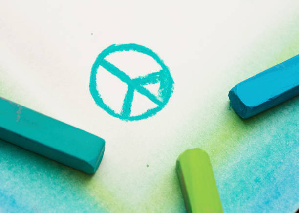 Green and blue pastel crayons have sketched the international symbol of the Campaign for Nuclear Disarmament or CND.