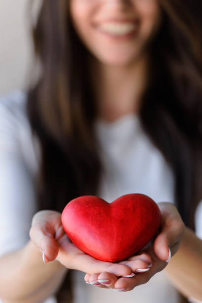 istock Red Heart on Woman's Palms. Love Symbol 1006529880