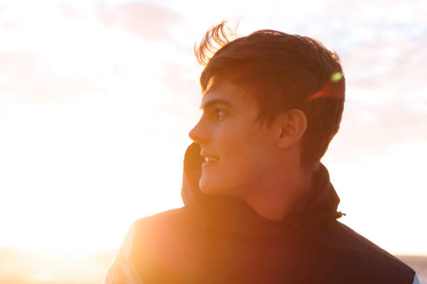 istock the young man admires the sunset, cute young man at dawn 1006532058