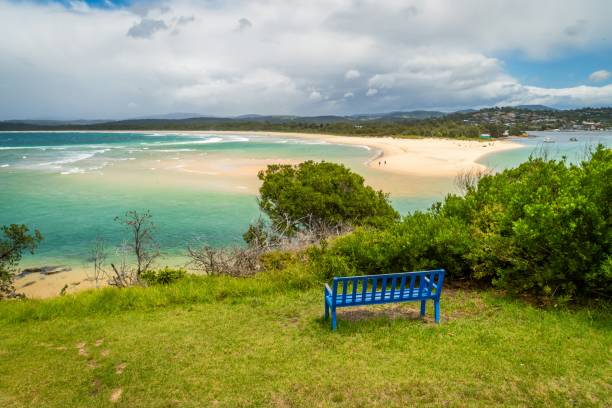 Bench in front of Merimbula bay in New South Wales stock photo