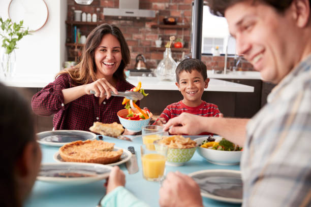 istock Family Enjoying Meal Around Table At Home Together 1006538486