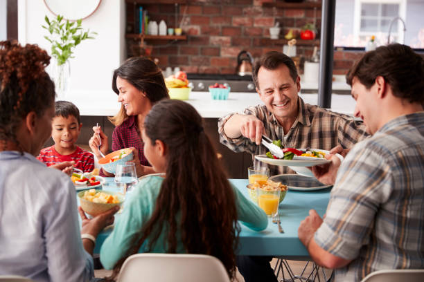 istock Multi Generation Family Enjoying Meal Around Table At Home Together 1006538496
