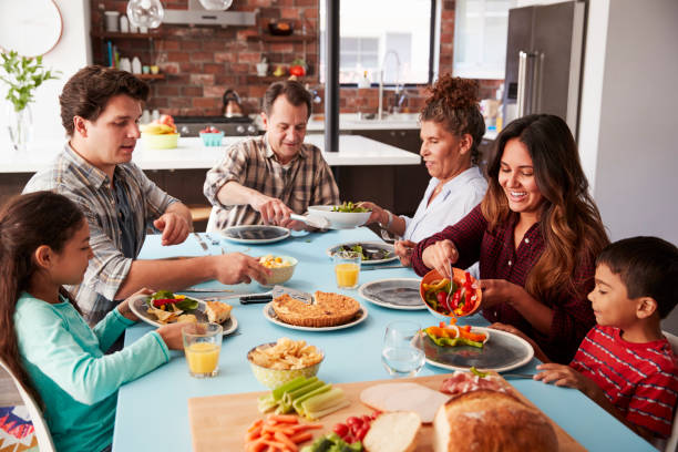 istock Multi Generation Family Enjoying Meal Around Table At Home Together 1006538562