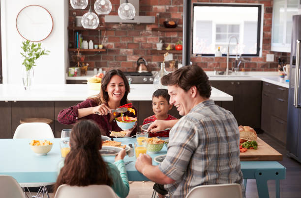 istock Family Enjoying Meal Around Table At Home Together 1006538656
