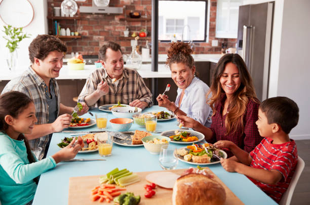 istock Multi Generation Family Enjoying Meal Around Table At Home Together 1006538708