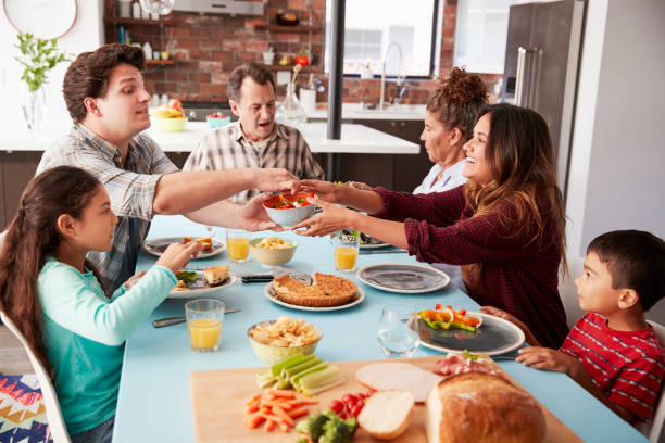 istock Multi Generation Family Enjoying Meal Around Table At Home Together 1006538774