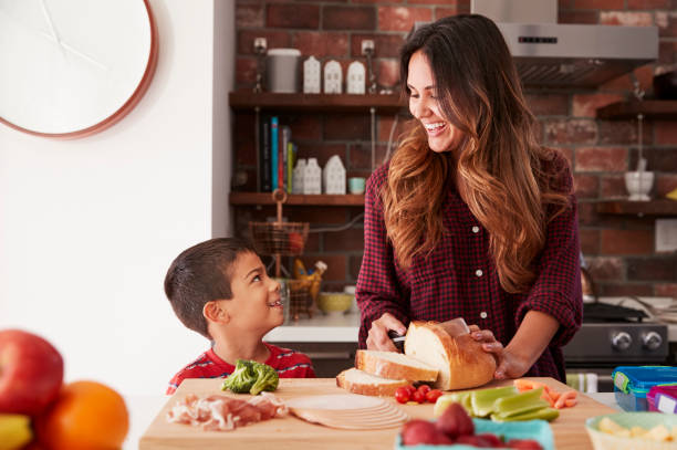 istock Mother And Son Making School Lunch In Kitchen At Home 1006539000