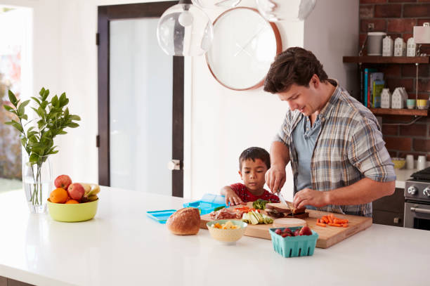 istock Father And Son Making School Lunch In Kitchen At Home 1006539152