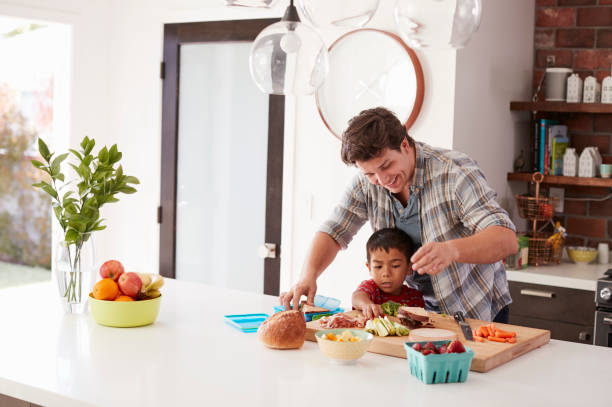 istock Father And Son Making School Lunch In Kitchen At Home 1006539182