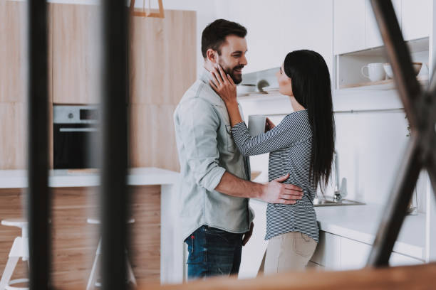 istock Young Happy Couple Hugging in Modern Kitchen. 1006542766