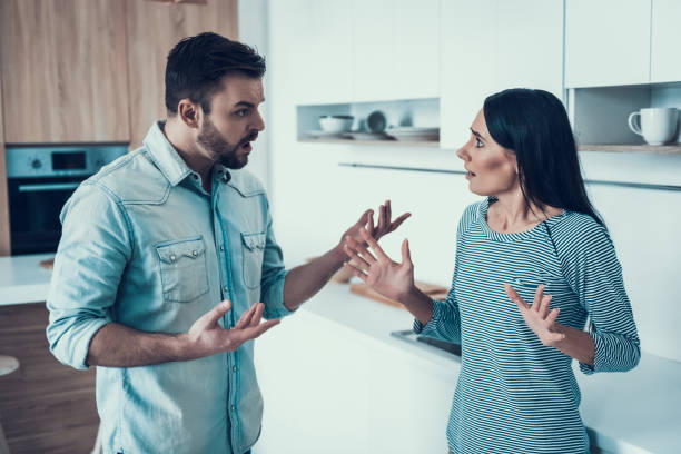istock Young Couple Have Disagreement in Kitchen at Home. 1006542774