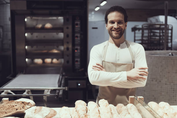 istock Smiling Baker in Bakery Department in Supermarket. 1006543018