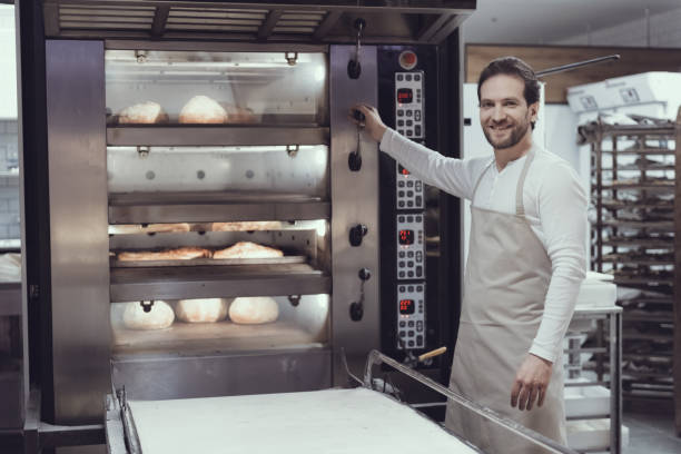 istock Smiling Baker in Bakery Department in Supermarket. 1006543066