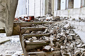 Stairwell concrete buildings littered with debris of stones and concrete