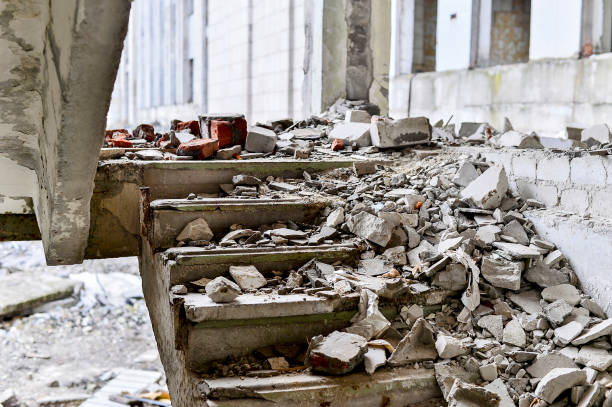 Stairwell concrete buildings littered with debris of stones and concrete Stairwell concrete buildings littered with debris of stones and concrete. destruction stock pictures, royalty-free photos & images