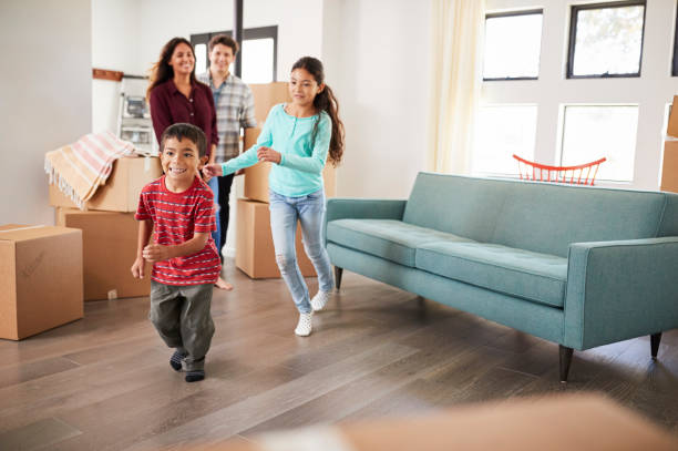 istock Excited Family Surrounded By Boxes Exploring New Home On Moving Day 1006547176